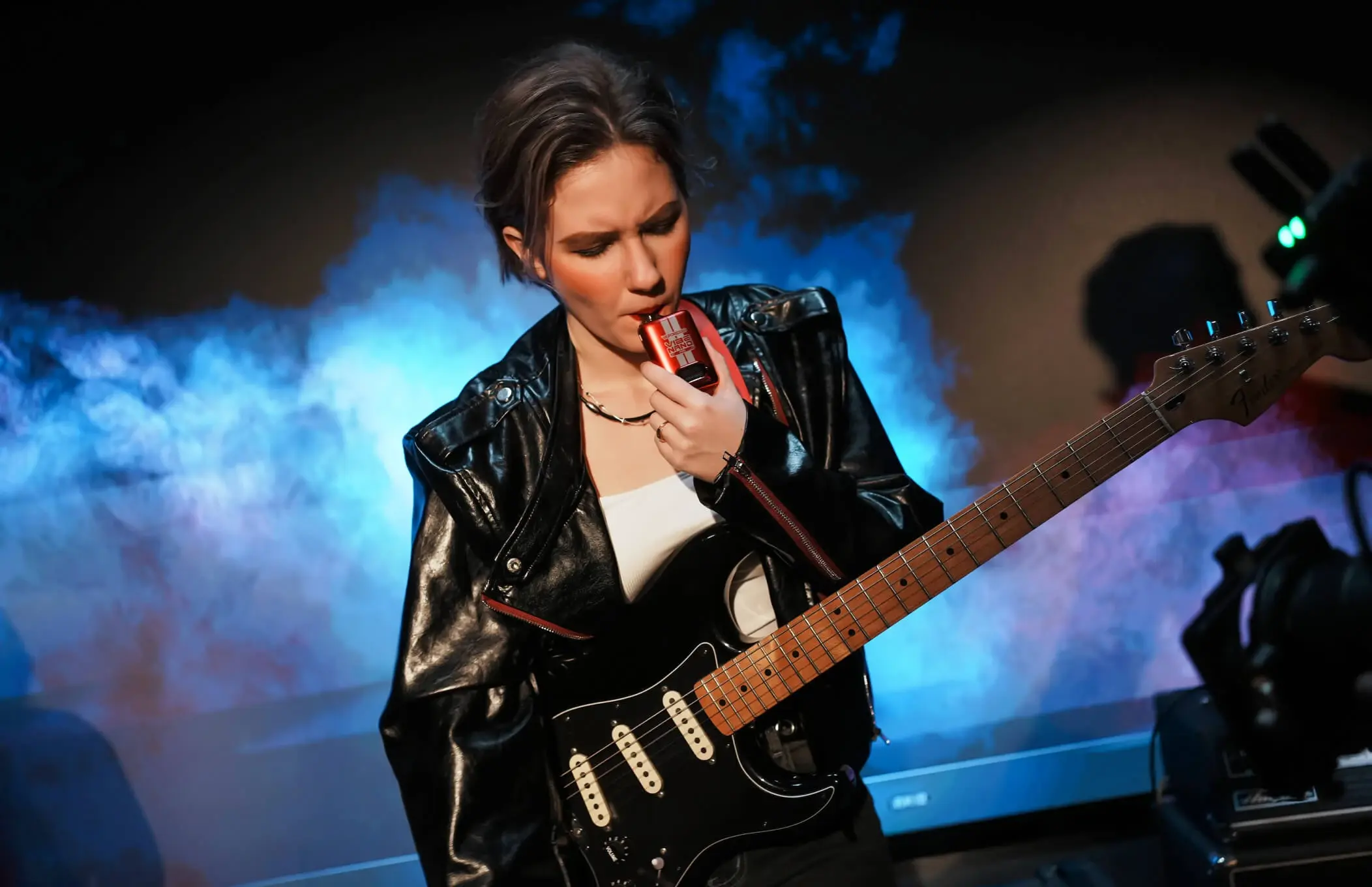 A musician enjoys the great flavor from a VAPORESSO flavor vape, demonstrating the lasting taste from its Dual Mesh coil vape technology.